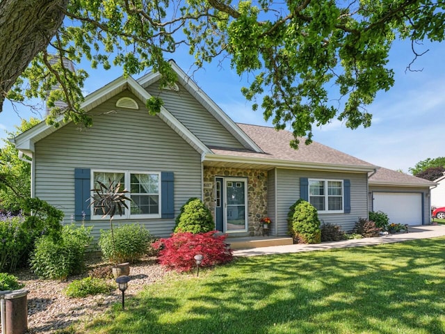 26317 Dukleth Dr, Waterford, WI 53185 - view of front facade with a front yard, roof with shingles, an attached garage, and stone siding