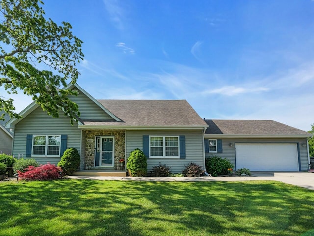 26317 Dukleth Dr, Waterford, WI 53185 - view of front of house featuring a front lawn, an attached garage, driveway, a shingled roof, and stone siding