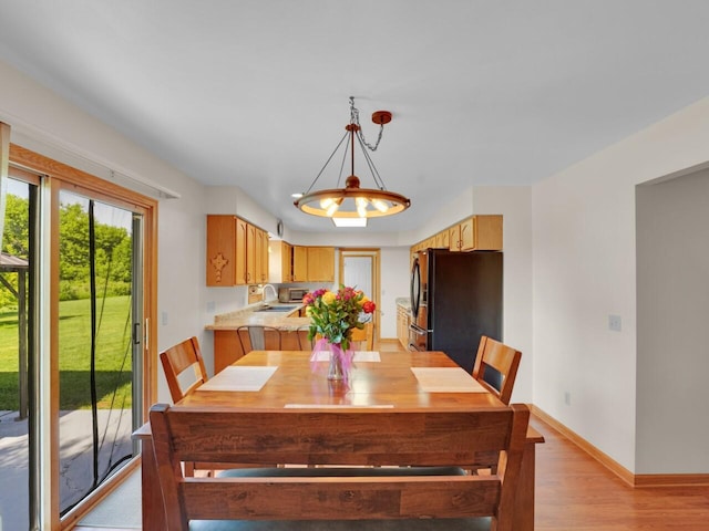 26317 Dukleth Dr, Waterford, WI 53185 - dining space featuring light wood finished floors and baseboards