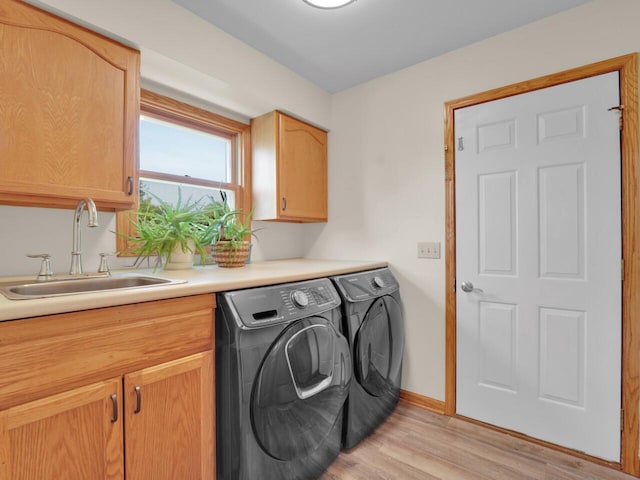 26317 Dukleth Dr, Waterford, WI 53185 - washroom with cabinet space, washing machine and clothes dryer, and light wood-style flooring