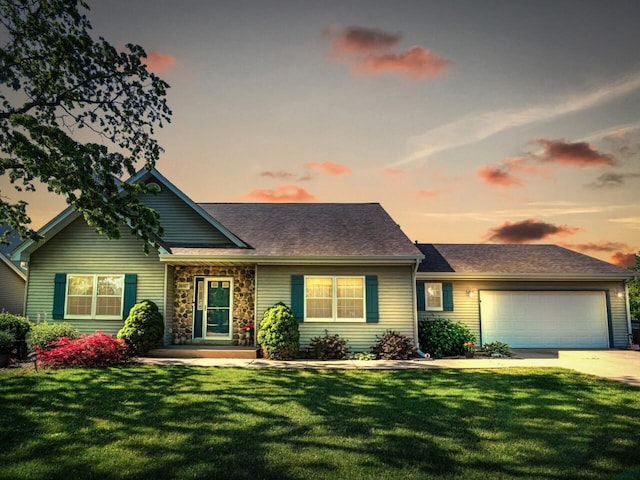 26317 Dukleth Dr, Waterford, WI 53185 - view of front of house featuring a front lawn, an attached garage, driveway, and stone siding