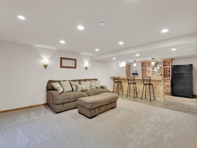 26317 Dukleth Dr, Waterford, WI 53185 - living area featuring bar with sink, light colored carpet, and recessed lighting