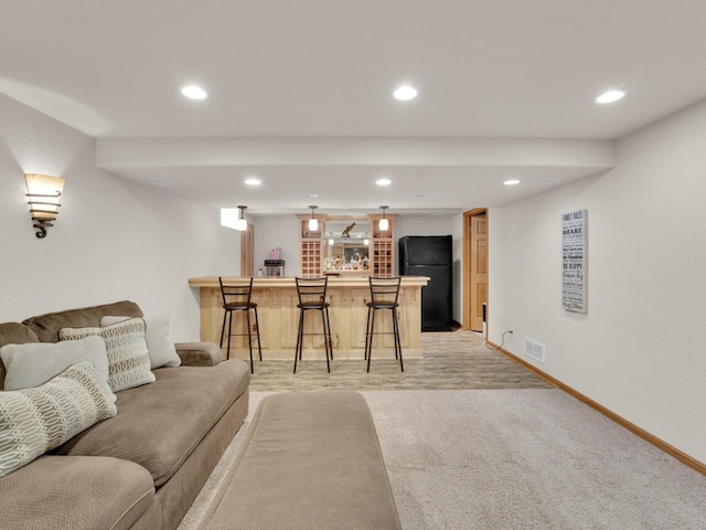 26317 Dukleth Dr, Waterford, WI 53185 - living room with bar with sink, recessed lighting, and light carpet