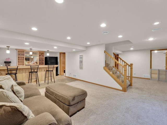 26317 Dukleth Dr, Waterford, WI 53185 - living room with recessed lighting, stairway, light carpet, and bar area