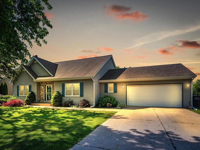 26317 Dukleth Dr, Waterford, WI 53185 - view of front of property featuring a garage, driveway, a front lawn, and a shingled roof
