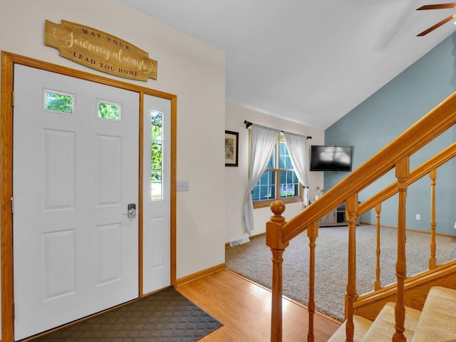 26317 Dukleth Dr, Waterford, WI 53185 - foyer featuring wood finished floors, ceiling fan, stairs, lofted ceiling, and carpet flooring