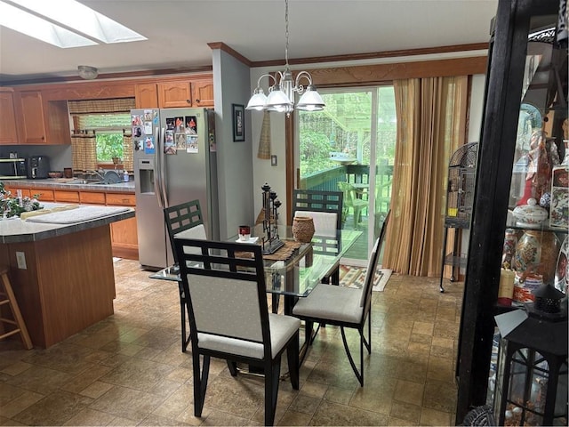 733 W Old Highway 54, Pittsville, WI 54466 - dining room with stone finish flooring, a skylight, ornamental molding, and plenty of natural light