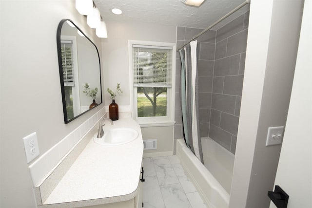 4201 Janick Cir, Stevens Point, WI 54481 - full bathroom with marble finish flooring, vanity, shower / tub combo, and a textured ceiling