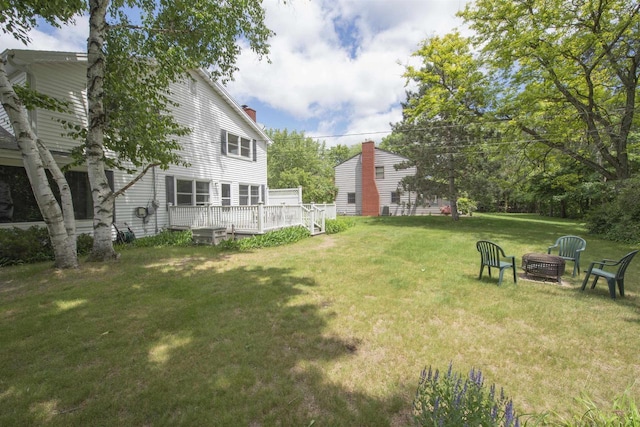 4201 Janick Cir, Stevens Point, WI 54481 - view of green lawn with an outdoor fire pit and a deck