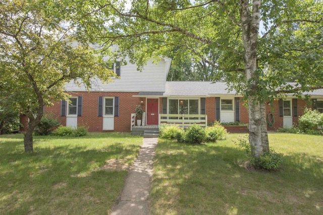 4201 Janick Cir, Stevens Point, WI 54481 - view of front of house with a front yard and brick siding