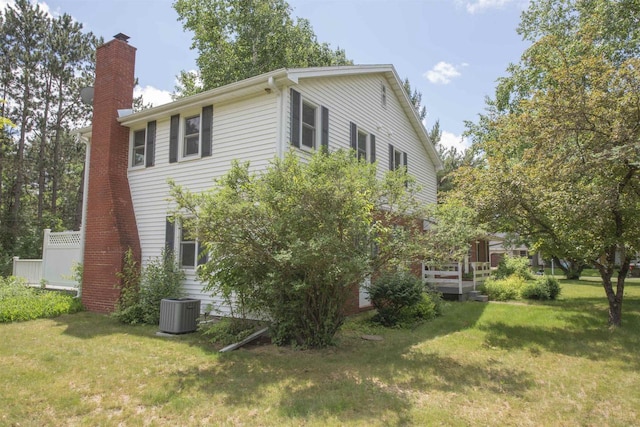 4201 Janick Cir, Stevens Point, WI 54481 - view of side of property with a chimney and a yard