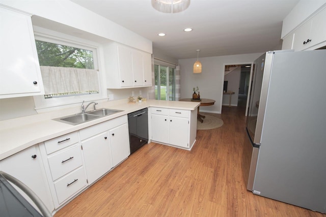 4201 Janick Cir, Stevens Point, WI 54481 - kitchen with freestanding refrigerator, dishwasher, a peninsula, light countertops, and plenty of natural light