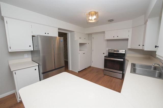 4201 Janick Cir, Stevens Point, WI 54481 - kitchen featuring stainless steel appliances, dark wood-style floors, white cabinetry, light countertops, and a peninsula