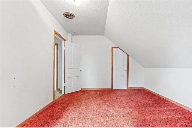 W3767 750th Ave, Spring Valley, WI 54767 - additional living space featuring a textured ceiling, lofted ceiling, and carpet floors