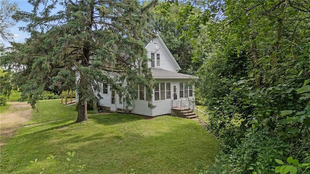 W3767 750th Ave, Spring Valley, WI 54767 - view of property exterior with a sunroom and a yard
