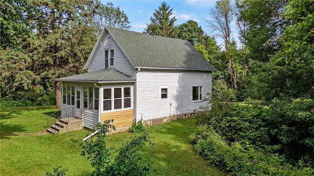 W3767 750th Ave, Spring Valley, WI 54767 - view of home's exterior featuring roof with shingles, a lawn, and a sunroom