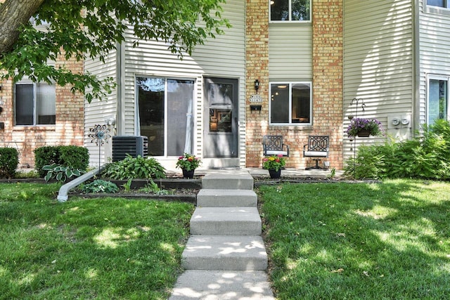 W169N11470 Biscayne Dr Unit 7, Germantown, WI 53022 - doorway to property with a lawn and brick siding