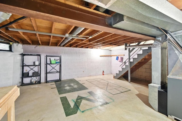 W169N11470 Biscayne Dr Unit 7, Germantown, WI 53022 - unfinished below grade area featuring stairway, concrete block wall, and heating unit