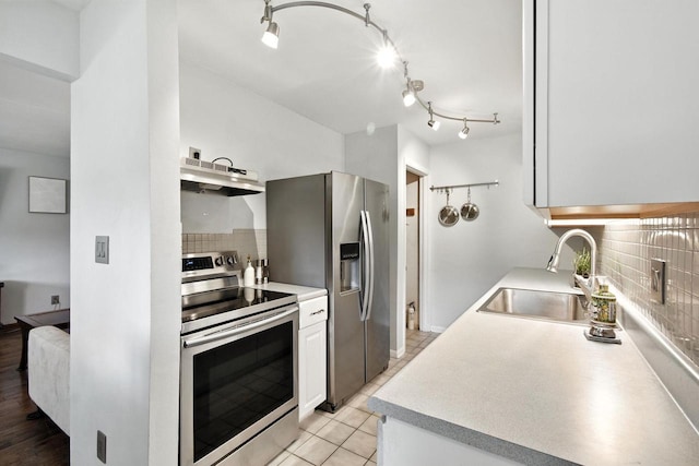 W169N11470 Biscayne Dr Unit 7, Germantown, WI 53022 - kitchen with appliances with stainless steel finishes, under cabinet range hood, backsplash, and light countertops