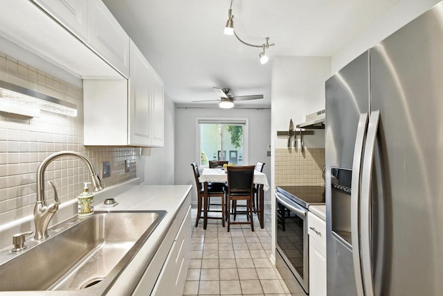 W169N11470 Biscayne Dr Unit 7, Germantown, WI 53022 - kitchen with appliances with stainless steel finishes, backsplash, light countertops, wall chimney range hood, and light tile patterned floors
