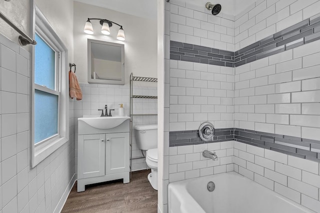 4904 25th Ave, Kenosha, WI 53140 - full bathroom with vanity, tile walls, plenty of natural light, wood finished floors, and shower / tub combination
