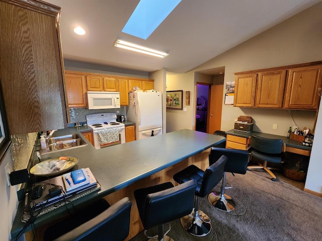 584 N Wisconsin St, Berlin, WI 54923 - kitchen with white appliances, a peninsula, a kitchen breakfast bar, carpet floors, and a desk