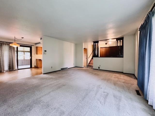 2709 Richard St, Marinette, WI 54143 - unfurnished living room featuring light carpet and stairs