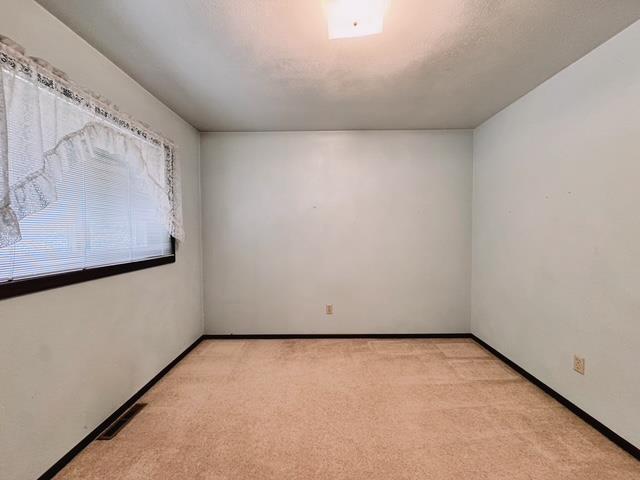 2709 Richard St, Marinette, WI 54143 - spare room with light colored carpet and baseboards