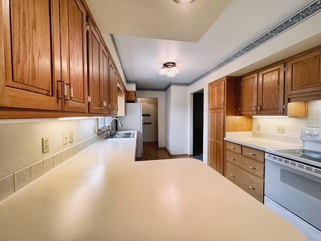 2709 Richard St, Marinette, WI 54143 - kitchen featuring white electric range, light countertops, and brown cabinets