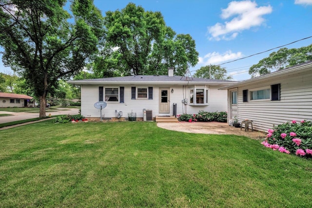 1981 Jan Ave, Waukesha, WI 53188 - view of front facade with a front yard and a chimney