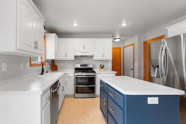 2847 Virgo Rd, Green Bay, WI 54311 - kitchen with stainless steel appliances, blue cabinets, under cabinet range hood, white cabinets, and light countertops