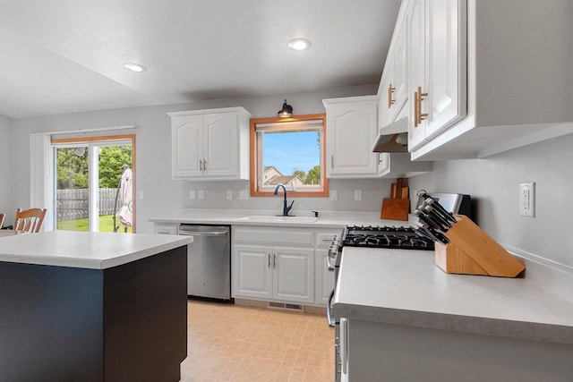2847 Virgo Rd, Green Bay, WI 54311 - kitchen with appliances with stainless steel finishes, white cabinets, light countertops, recessed lighting, and under cabinet range hood