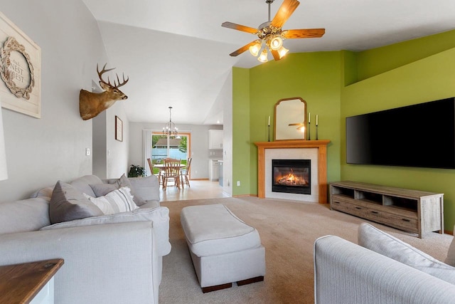 2847 Virgo Rd, Green Bay, WI 54311 - living room featuring vaulted ceiling, light colored carpet, ceiling fan, a chandelier, and a glass covered fireplace