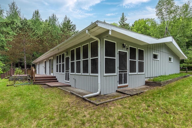 9315 N Shore Dr, Harshaw, WI 54529 - view of home's exterior featuring board and batten siding, a lawn, and a deck