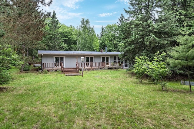 9315 N Shore Dr, Harshaw, WI 54529 - view of front of home featuring a deck, a front yard, and a forest view