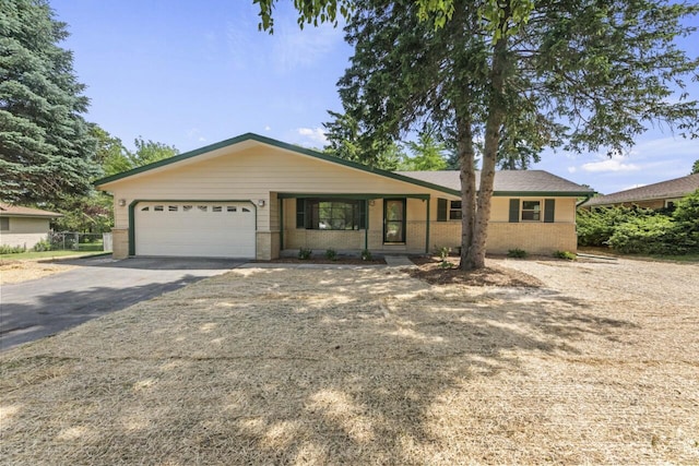 6101 W Edgerton Ave, Greendale, WI 53129 - ranch-style home with an attached garage, asphalt driveway, and brick siding