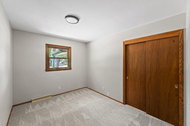 6101 W Edgerton Ave, Greendale, WI 53129 - unfurnished bedroom with carpet floors, a closet, and baseboard heating