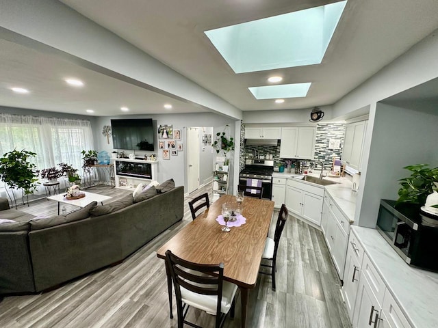 5510 W Luebbe Ln, Milwaukee, WI 53223 - dining room featuring wood finished floors, a skylight, and recessed lighting