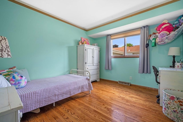 7939 32nd Ave, Kenosha, WI 53144 - bedroom with ornamental molding and light wood-style floors
