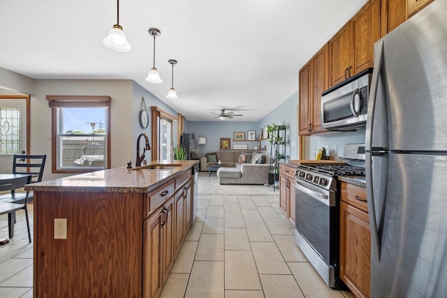 7939 32nd Ave, Kenosha, WI 53144 - kitchen with appliances with stainless steel finishes, brown cabinetry, ceiling fan, and pendant lighting