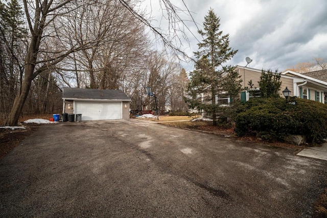 1100 W Fairy Chasm Rd, River Hills, WI 53217 - view of home's exterior featuring a garage and an outbuilding