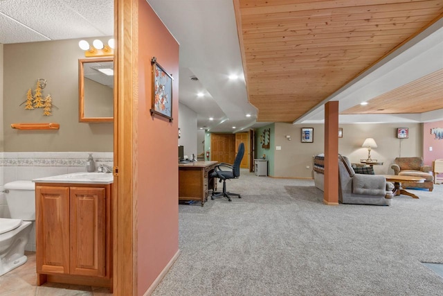 W11686 Buttercup Ave, Hancock, WI 54943 - living room featuring light carpet, a desk, a wainscoted wall, recessed lighting, and tile walls