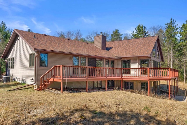 W11686 Buttercup Ave, Hancock, WI 54943 - rear view of house with a chimney, a wooden deck, and a shingled roof