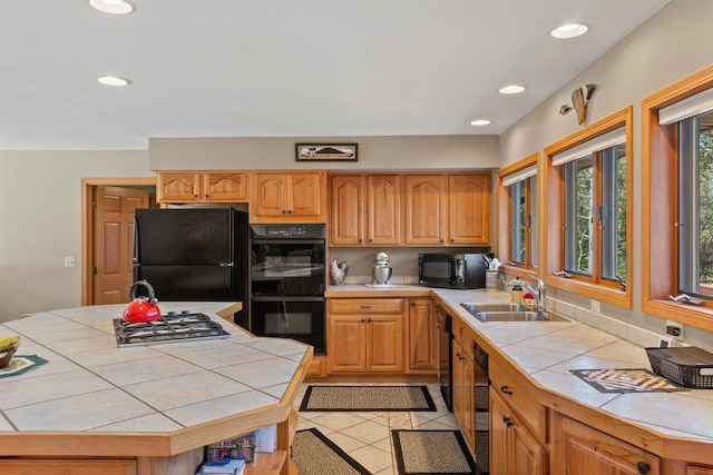 W11686 Buttercup Ave, Hancock, WI 54943 - kitchen featuring black appliances, tile countertops, light tile patterned floors, recessed lighting, and a kitchen island