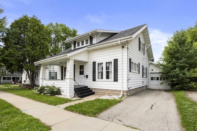 209 N Rankin St, Appleton, WI 54911 - view of front of home with a porch, a detached garage, and a shingled roof