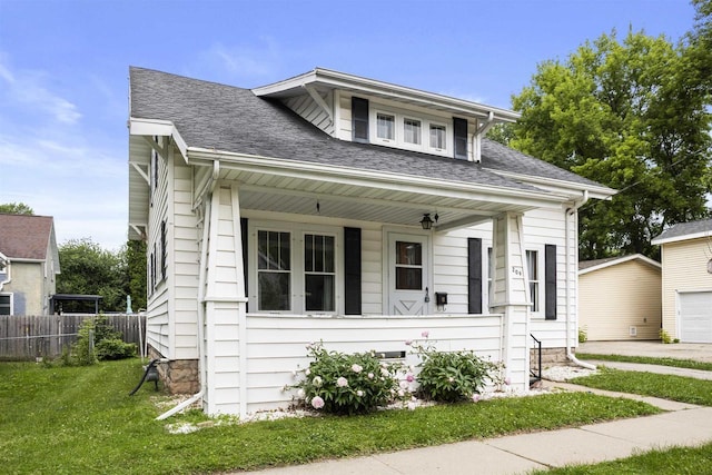 209 N Rankin St, Appleton, WI 54911 - bungalow-style house featuring a porch, roof with shingles, a garage, and an outdoor structure