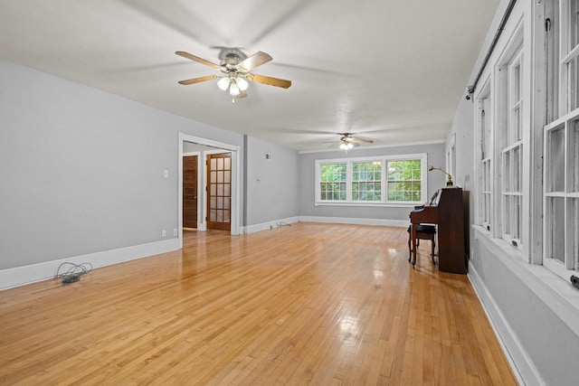 928 Emilie St, Green Bay, WI 54301 - unfurnished living room featuring a ceiling fan and light wood-type flooring