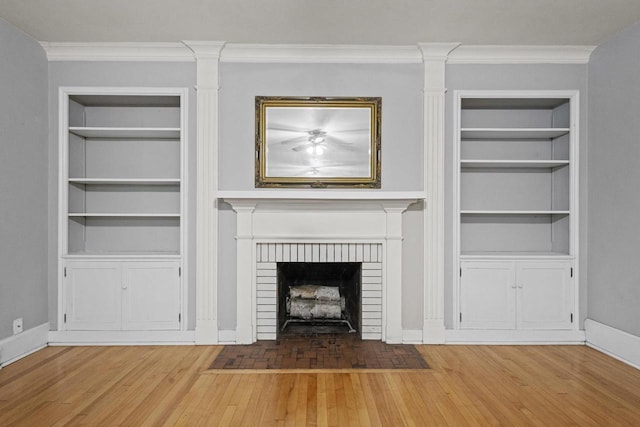 928 Emilie St, Green Bay, WI 54301 - unfurnished living room with built in features, a fireplace, ornamental molding, and wood finished floors