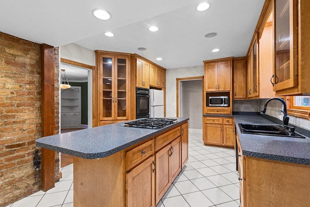 928 Emilie St, Green Bay, WI 54301 - kitchen featuring stainless steel appliances, dark countertops, light tile patterned flooring, brown cabinetry, and recessed lighting