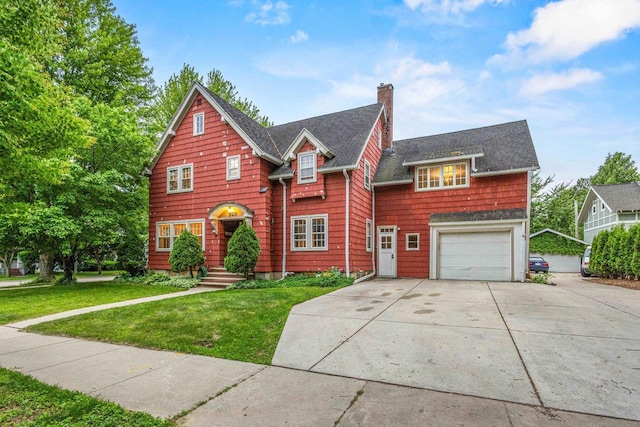 928 Emilie St, Green Bay, WI 54301 - view of front of house featuring a chimney, concrete driveway, a garage, a front lawn, and a shingled roof